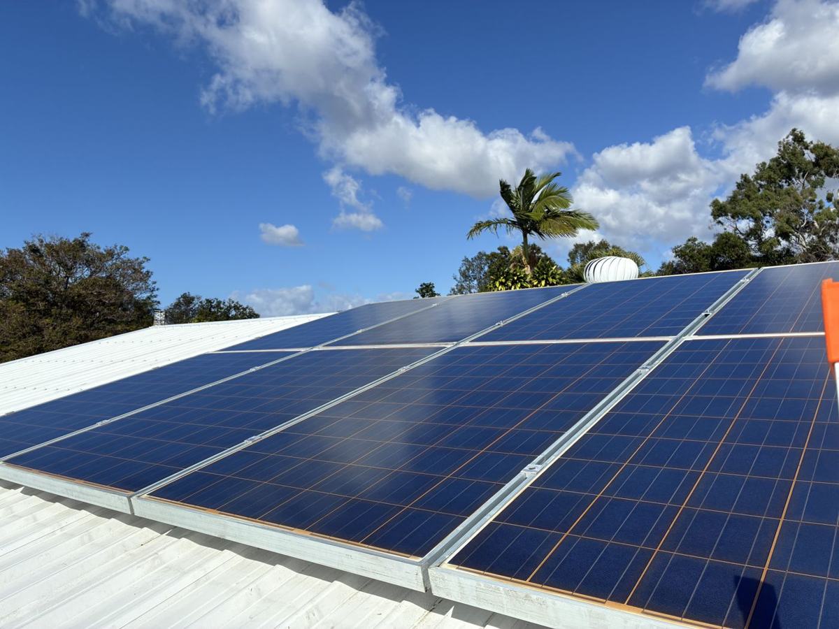 Clean solar panels on a roof under a blue sky